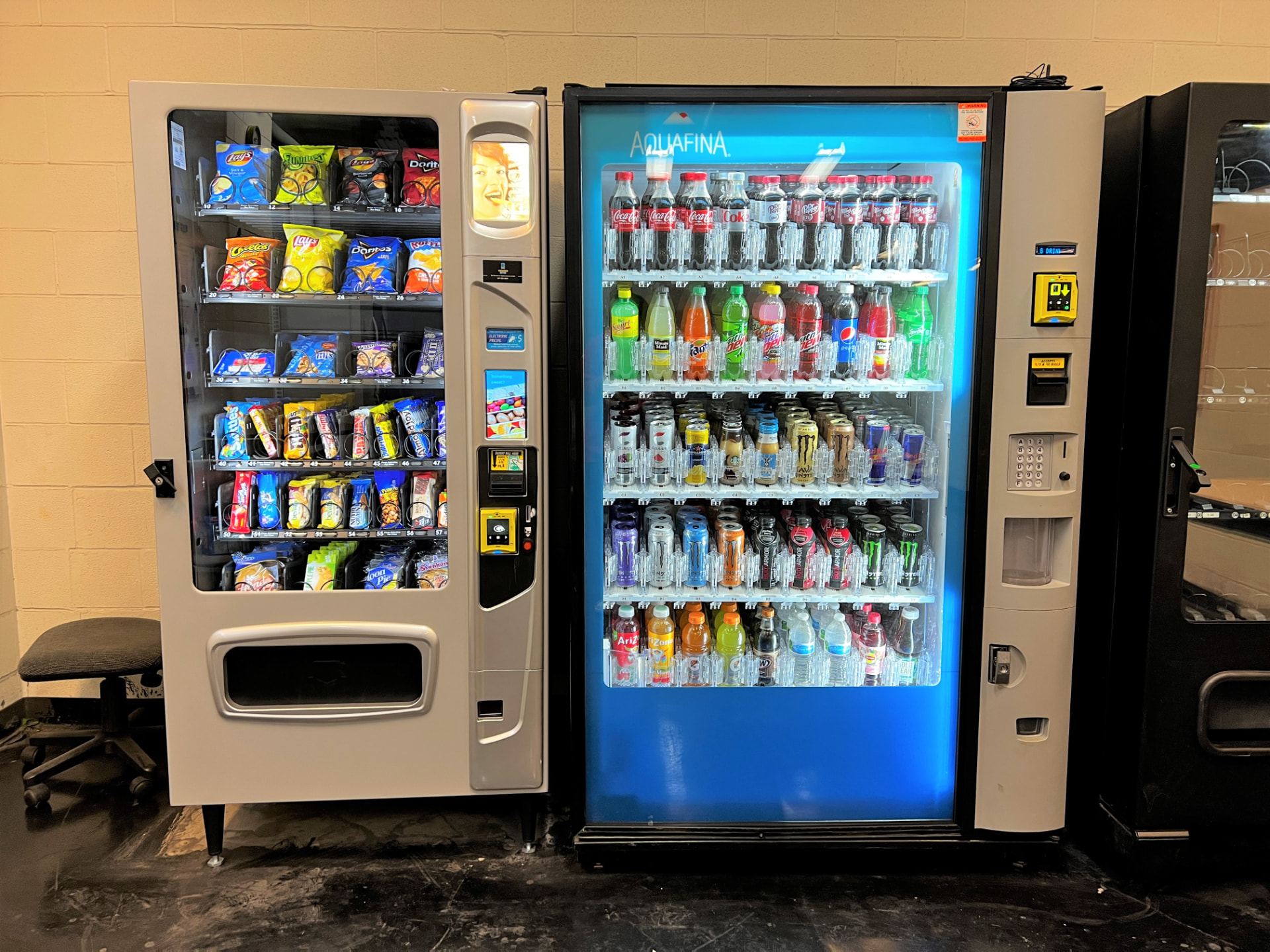 Snack and beverage vending machines installed side by side in a workplace breakroom